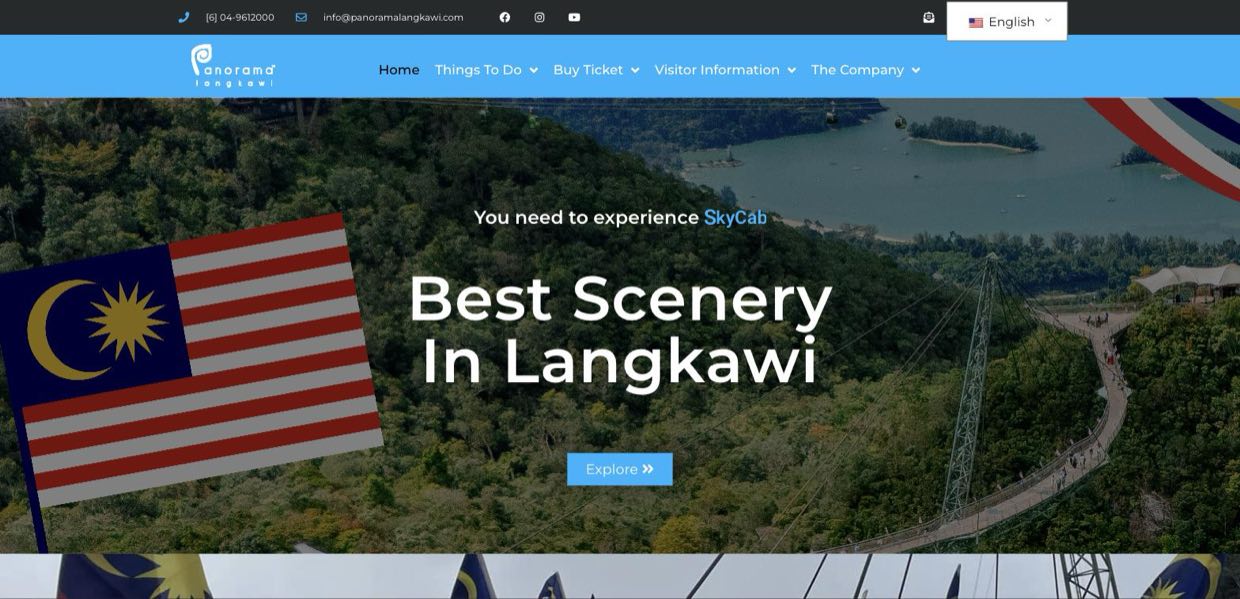 The homepage after dismissing the modal: a blue navigation bar, an aerial photograph of the SkyBridge, and a large Malaysian flag graphic covering the left third.